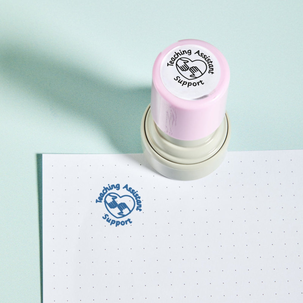 Teaching Assistant Support Stamp — the teacher marking stamp shown with its blue ink impression on dotted paper. My Teacher Says, handmade in Scotland.