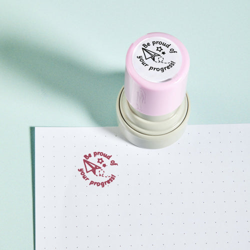 Be Proud Stamp — the teacher marking stamp shown with its red ink impression on dotted paper. My Teacher Says, handmade in Scotland.
