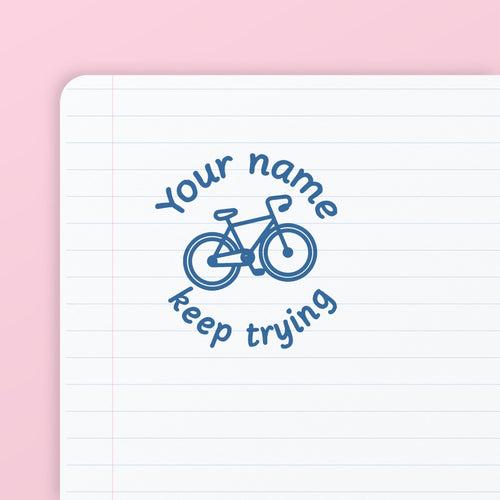 Blue ink impression from the Bicycle Keep Trying Stamp, on lined paper. My Teacher Says, handmade in Scotland.