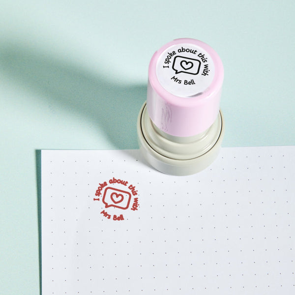 I Spoke About This With Stamp — the teacher marking stamp shown with its red ink impression, personalised with the teacher's name, on dotted paper. My Teacher Says, handmade in Scotland.