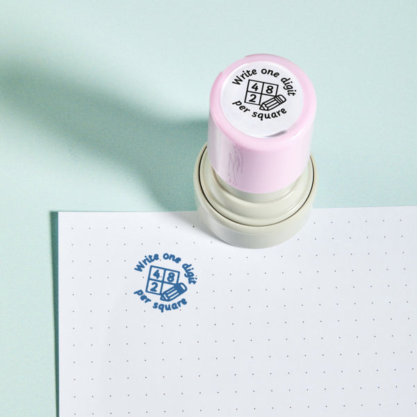 Maths Book Stamp — the teacher marking stamp shown with its blue ink impression on dotted paper. My Teacher Says, handmade in Scotland.
