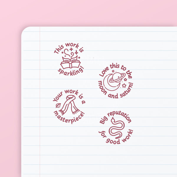 Pop Star Stamp Set 2 - the four teacher marking stamps in the set, stamped in pink ink on lined paper: sparkling, moon and saturn, masterpiece and reputation. My Teacher Says, handmade in Scotland.