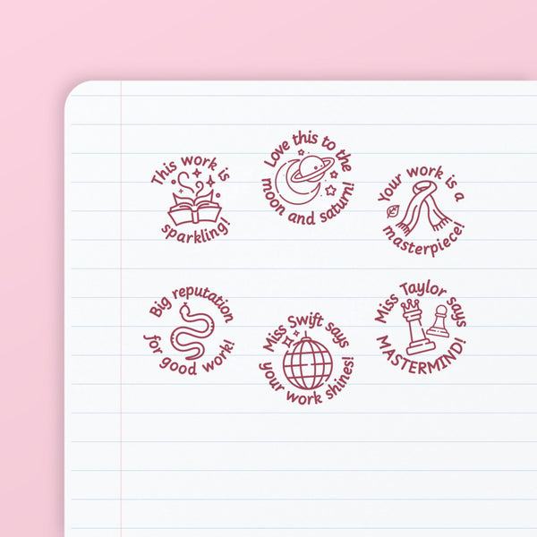 Pop Star Stamp Set 3 - the six teacher marking stamps in the set, stamped in pink ink on lined paper: sparkling, moon and saturn, masterpiece, reputation, discoball and mastermind. My Teacher Says, handmade in Scotland.